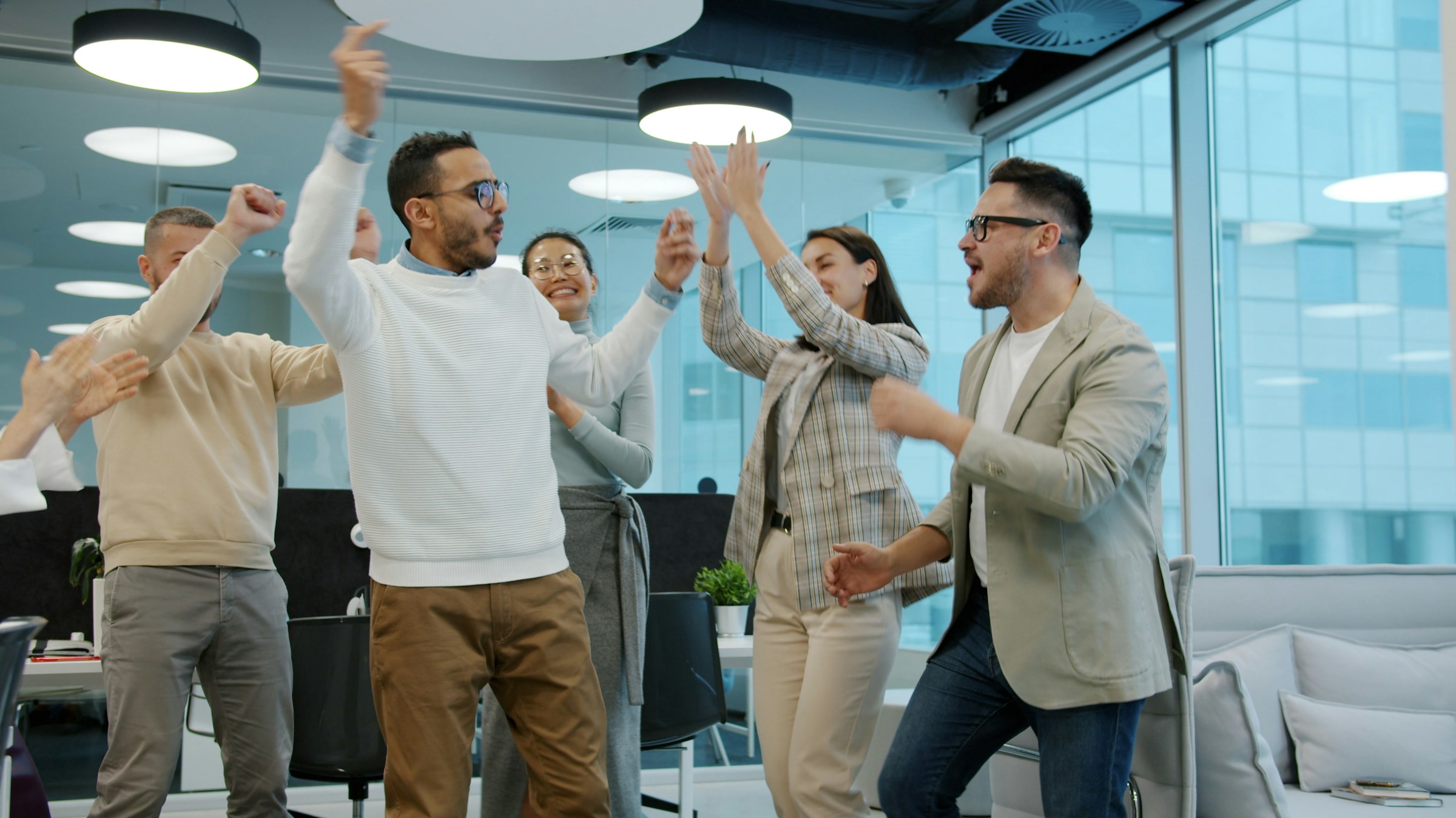 Team celebrating success in modern office